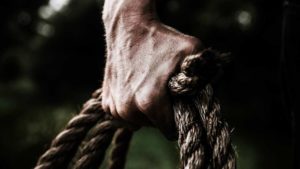 hand holding rope resiliently